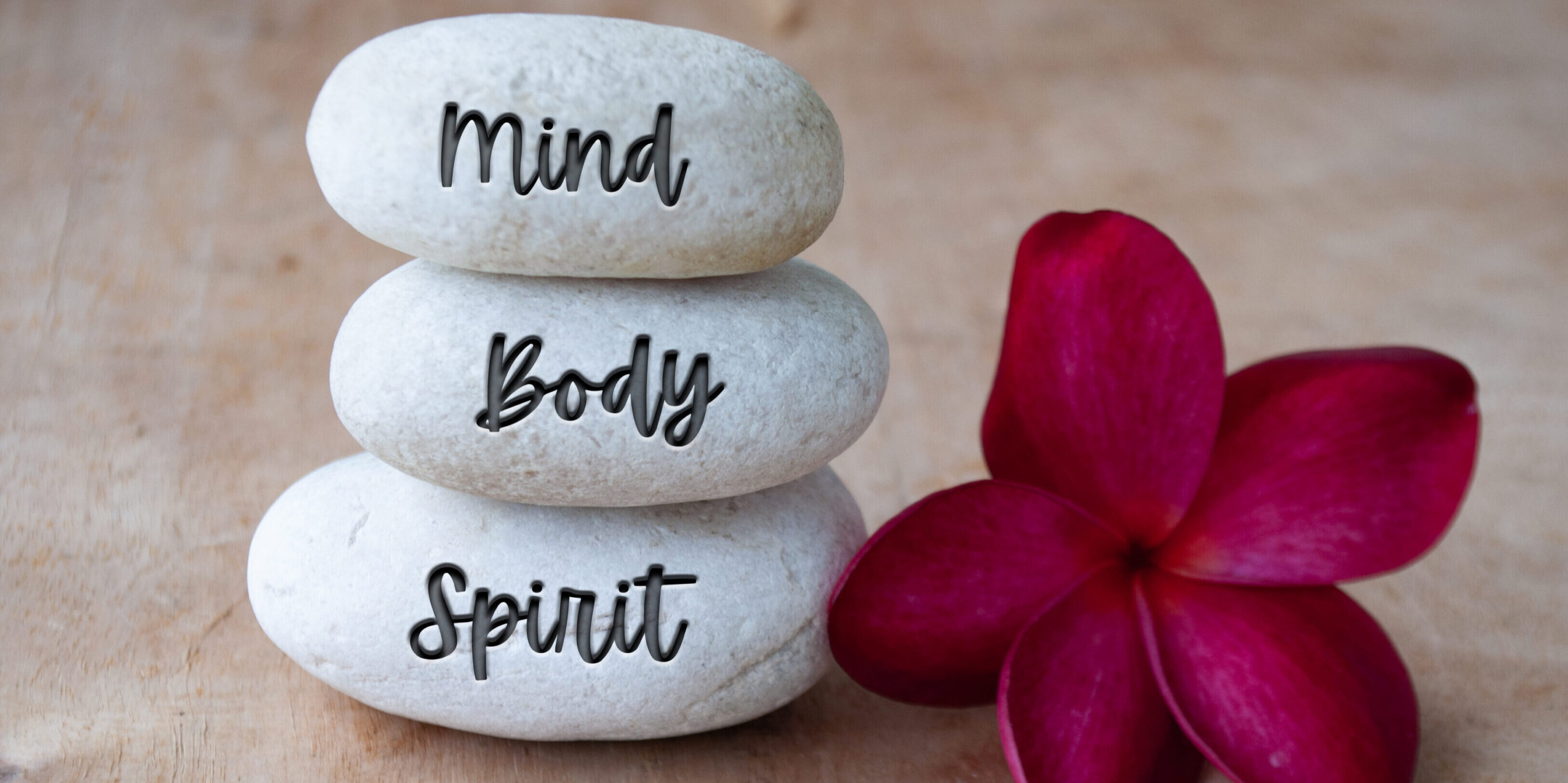 Mind, Body and Soul text engraved on white zen stones. Meditation and spa concept Mind, Body and Soul text engraved on white zen stones. Meditation and spa concept.